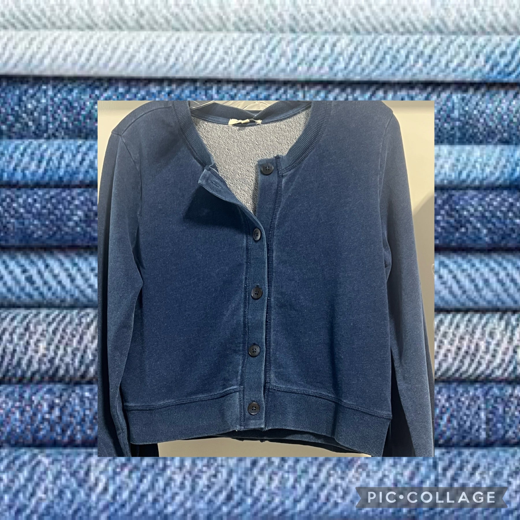 Z SUPPLY Cropped Terry Cardigan in dark blue indigo, shown on a hanger with a denim texture background.